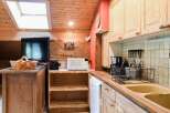 Cozy kitchen with wooden cabinets and a charming rustic design.