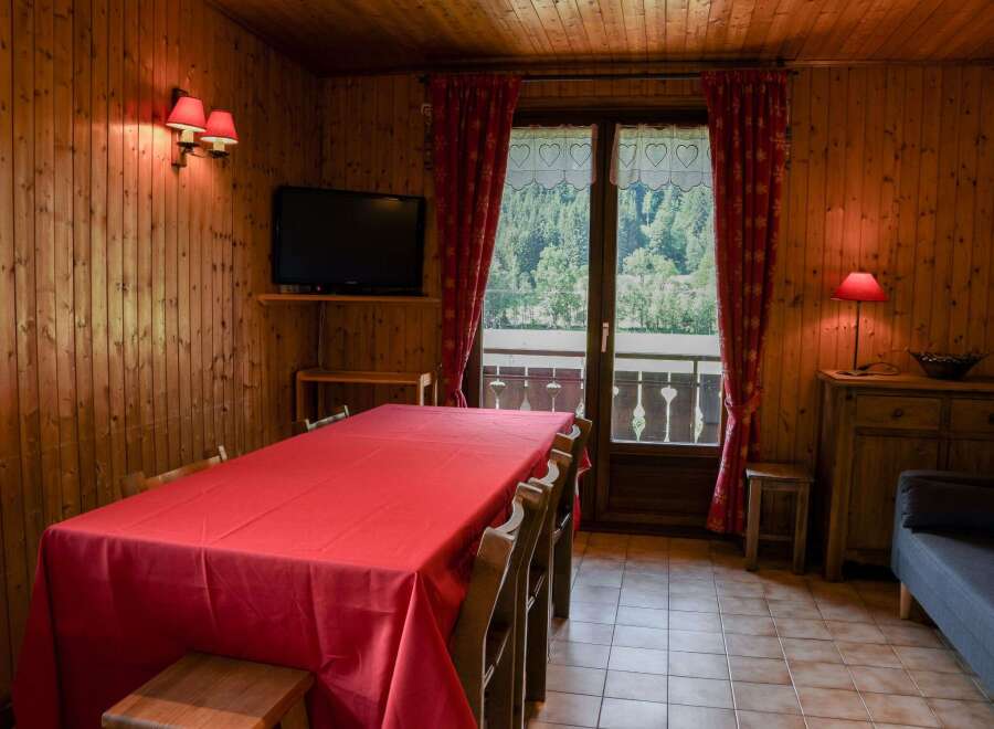 Cozy cabin retreat with rustic wooden walls and a charming dining area.