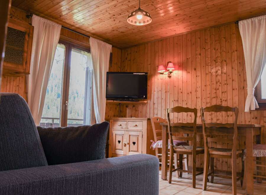 Cozy cabin living at its finest! This charming space features warm wood paneling, creating a rustic and inviting atmosphere.