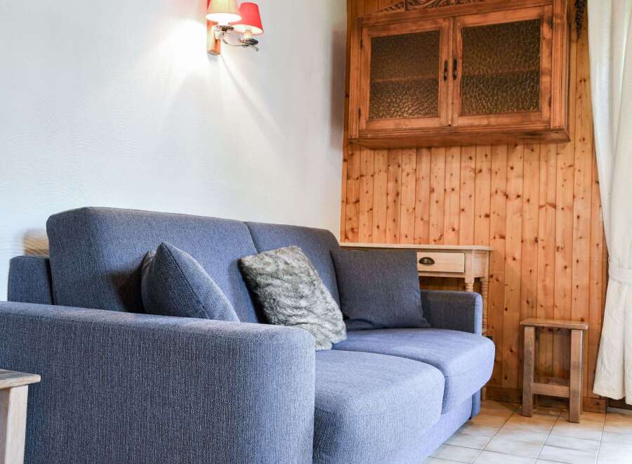Cozy living space featuring a comfortable blue sofa, perfect for relaxation.