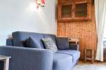 Cozy living space featuring a comfortable blue sofa, perfect for relaxation.
