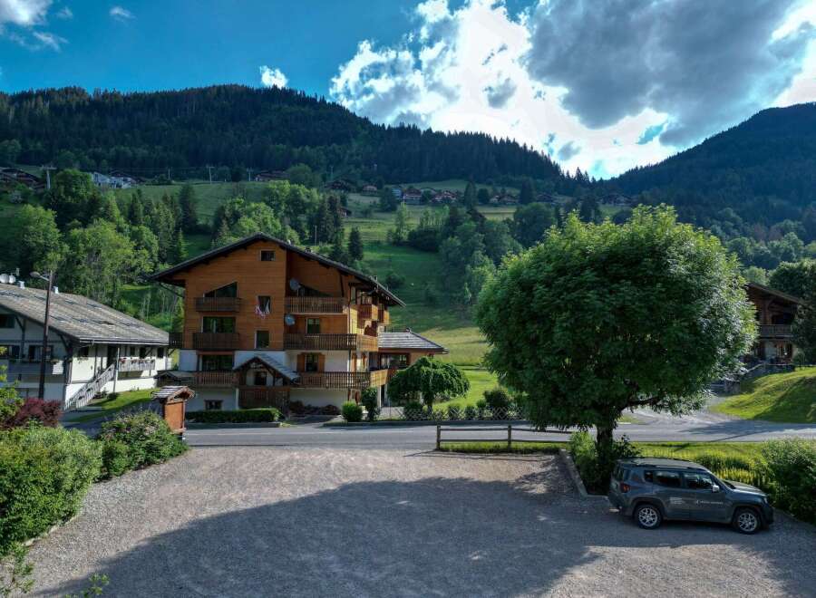 Discover a charming wooden chalet nestled in a picturesque mountain setting.
