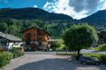 Discover a charming wooden chalet nestled in a picturesque mountain setting.