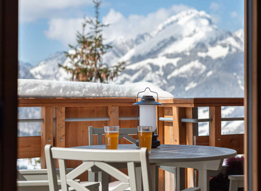 Enjoy breathtaking mountain views from this cozy balcony.