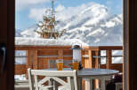 Enjoy breathtaking mountain views from this cozy balcony.