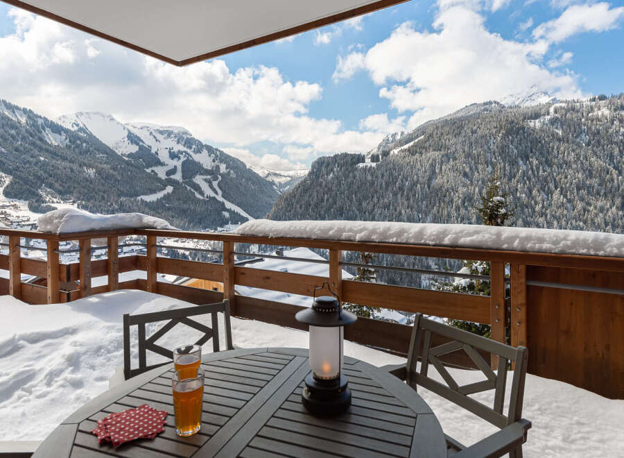 Enjoy breathtaking mountain views from this cozy balcony.