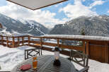 Enjoy breathtaking mountain views from this cozy balcony.