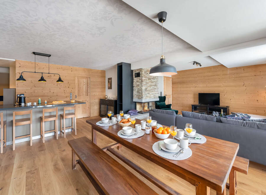 Experience luxury living in this stunning property, featuring a cozy fireplace and a spacious dining area perfect for gatherings.