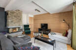Experience luxury living in this stunning property featuring a cozy fireplace and a modern entertainment setup.