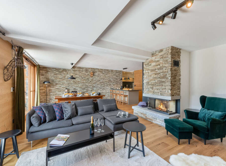 Experience luxury in this stunning chalet featuring a cozy fireplace and a spacious living area.