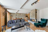 Experience luxury in this stunning chalet featuring a cozy fireplace and a spacious living area.