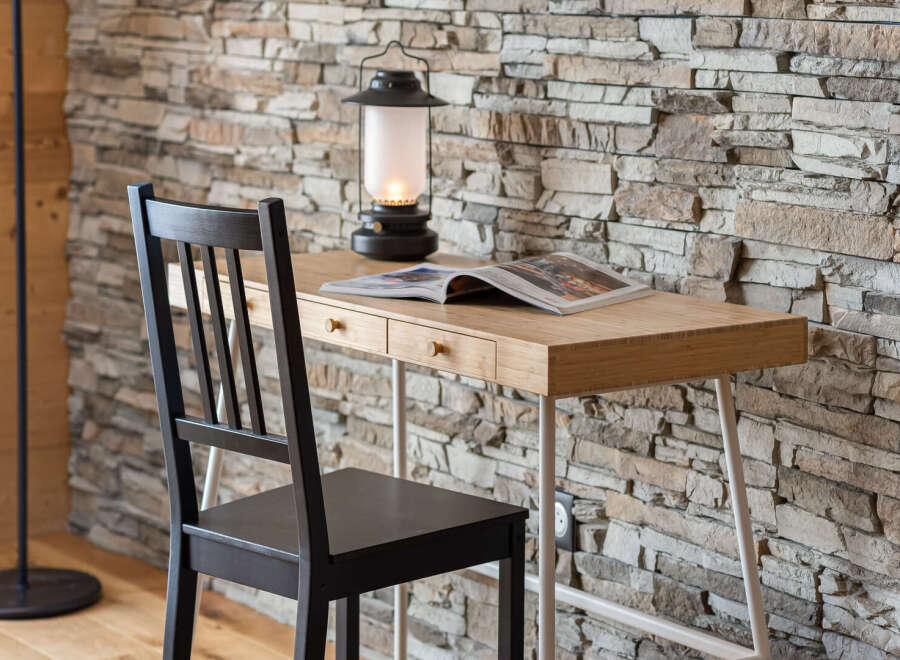 This cozy space features a stylish desk with a natural wood finish, perfect for work or leisure.