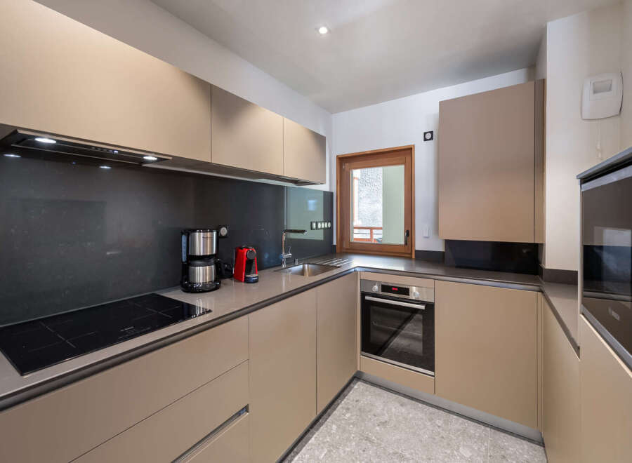 Discover a modern kitchen with sleek cabinetry and a stylish design.