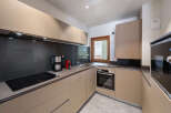 Discover a modern kitchen with sleek cabinetry and a stylish design.