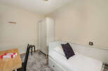 Discover a cozy bedroom featuring a comfortable bed with stylish pillows.