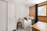 Discover a cozy bedroom retreat featuring a stylish white bed with storage drawers, perfect for maximizing space.