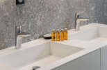 Indulge in luxury with this stunning bathroom featuring sleek, modern sinks and elegant chrome fixtures.