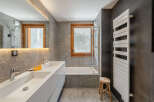 Discover a modern bathroom design featuring a sleek double vanity and a luxurious bathtub.