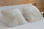 Cozy up in style with these luxurious white fur pillows.