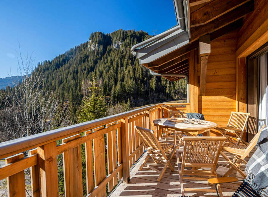 Enjoy breathtaking mountain views from this charming wooden balcony.