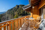 Enjoy breathtaking mountain views from this charming wooden balcony.
