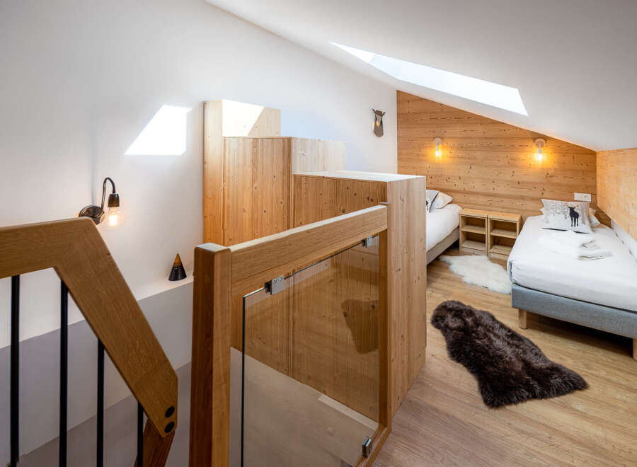 Discover a cozy retreat in this charming bedroom, featuring a blend of rustic wood and modern design.