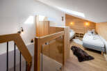 Discover a cozy retreat in this charming bedroom, featuring a blend of rustic wood and modern design.