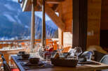 Enjoy breathtaking mountain views from this cozy dining area.