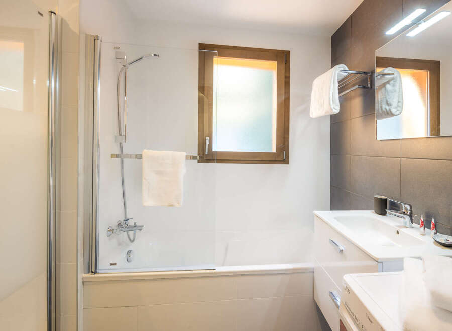 This modern bathroom features a sleek design with a glass shower enclosure and a stylish vanity.