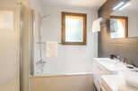 This modern bathroom features a sleek design with a glass shower enclosure and a stylish vanity.