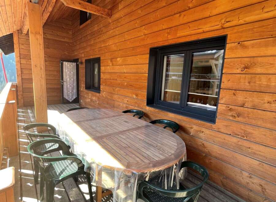 Enjoy the charm of this wooden cabin with a cozy outdoor space.