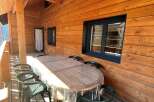 Enjoy the charm of this wooden cabin with a cozy outdoor space.