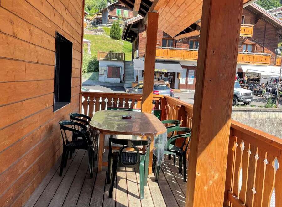 Enjoy the charm of this wooden balcony, perfect for relaxing and taking in the views.