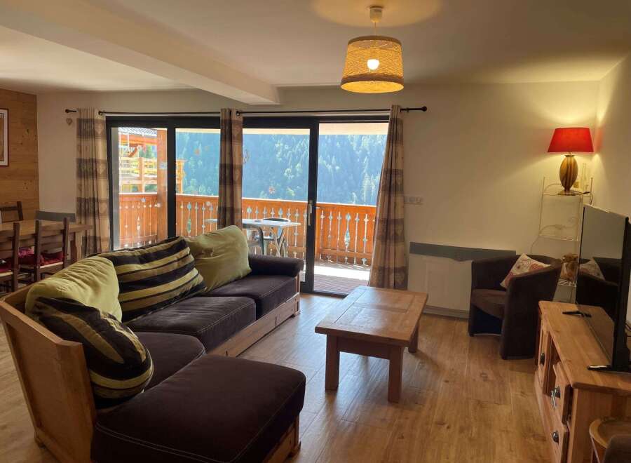 Cozy living room with a comfortable sofa and a charming wooden coffee table.