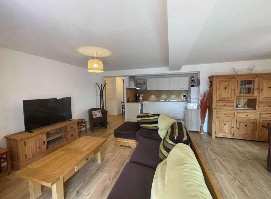 Discover a cozy living space with a comfortable sofa and a stylish wooden coffee table.
