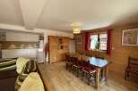 This charming property boasts a warm and inviting dining area, perfect for gatherings.