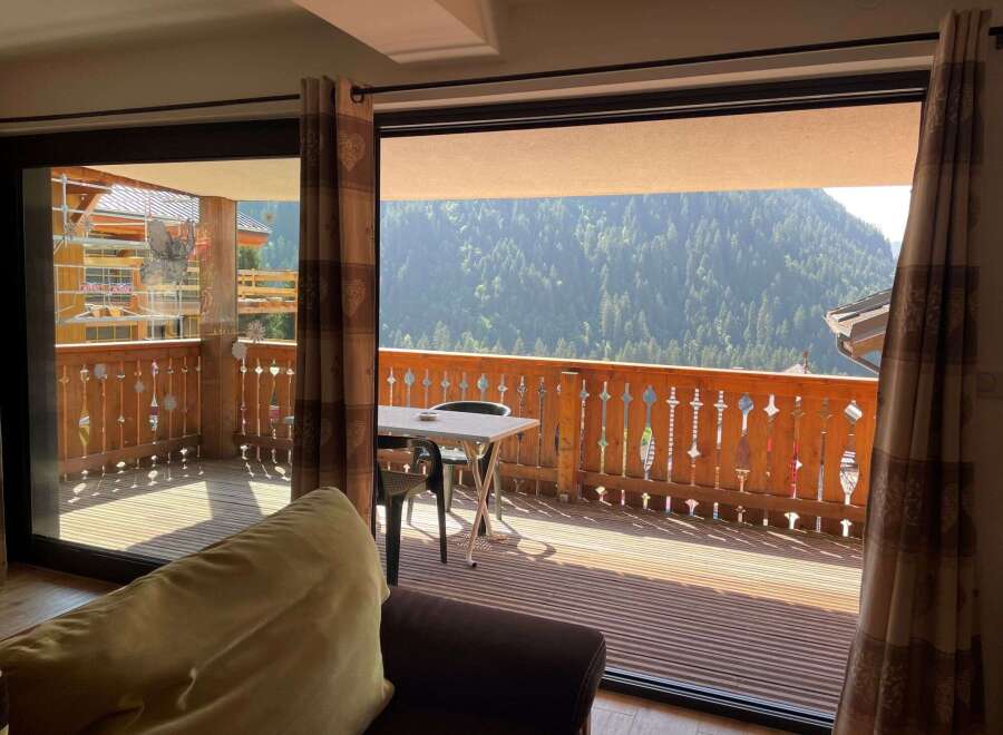 Enjoy breathtaking mountain views from this cozy balcony.