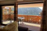 Enjoy breathtaking mountain views from this cozy balcony.