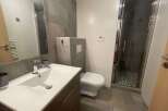This modern bathroom features a sleek design with a spacious shower and a stylish vanity.