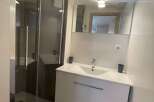 Discover a modern bathroom with a sleek shower enclosure.