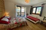 Cozy bedroom with a balcony offering stunning views.