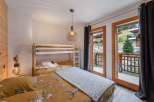 Cozy bedroom with a bunk bed and a comfortable double bed, perfect for families or groups.