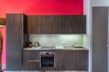 Modern kitchen design featuring dark wood cabinetry and a sleek stainless steel oven.