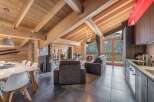 Experience luxury living in this stunning chalet, featuring a cozy fireplace and a modern kitchen.