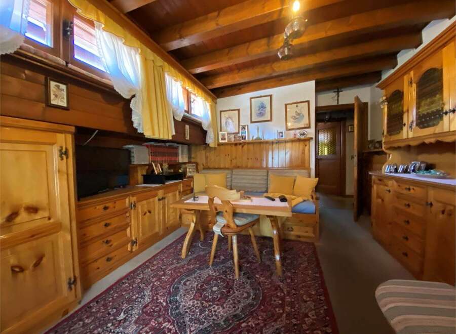 Step into a cozy and inviting living space with charming wooden accents.