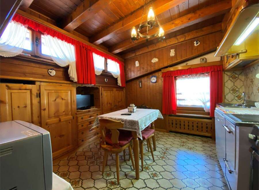 Step into a cozy, rustic kitchen with charming wooden paneling and a warm, inviting atmosphere.