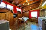 Step into a cozy, rustic kitchen with charming wooden paneling and a warm, inviting atmosphere.