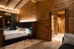 Experience luxury in this stunning bedroom featuring exquisite wooden paneling and a cozy ambiance.