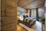 Experience luxury in this stunning bedroom featuring a cozy fur blanket and elegant headboard.