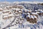 Experience the ultimate winter getaway in these stunning chalets nestled in a snowy mountain landscape.